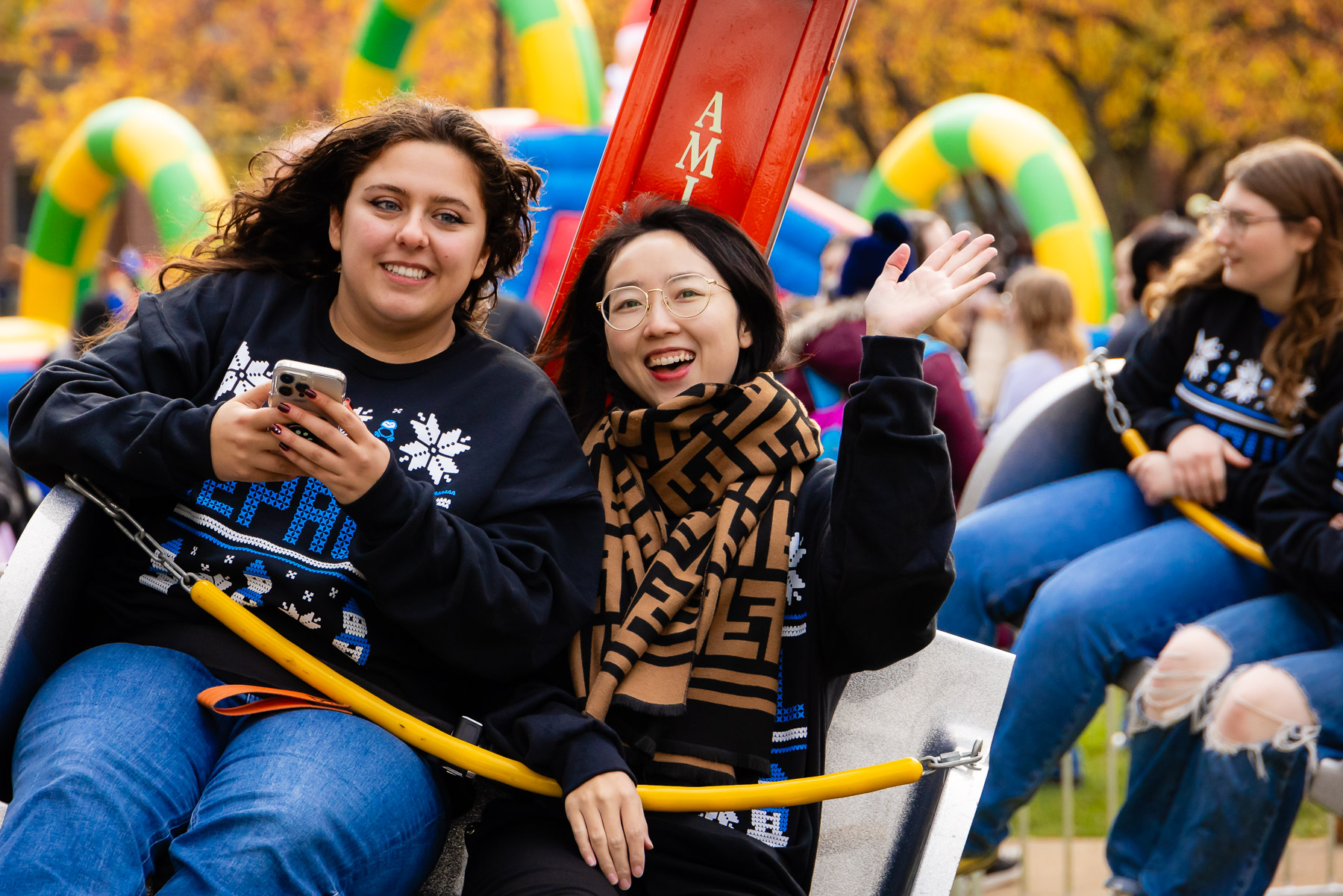 Students twirl on a carnival ride at the event. (Photo by Jeff Carrion / DePaul University) 